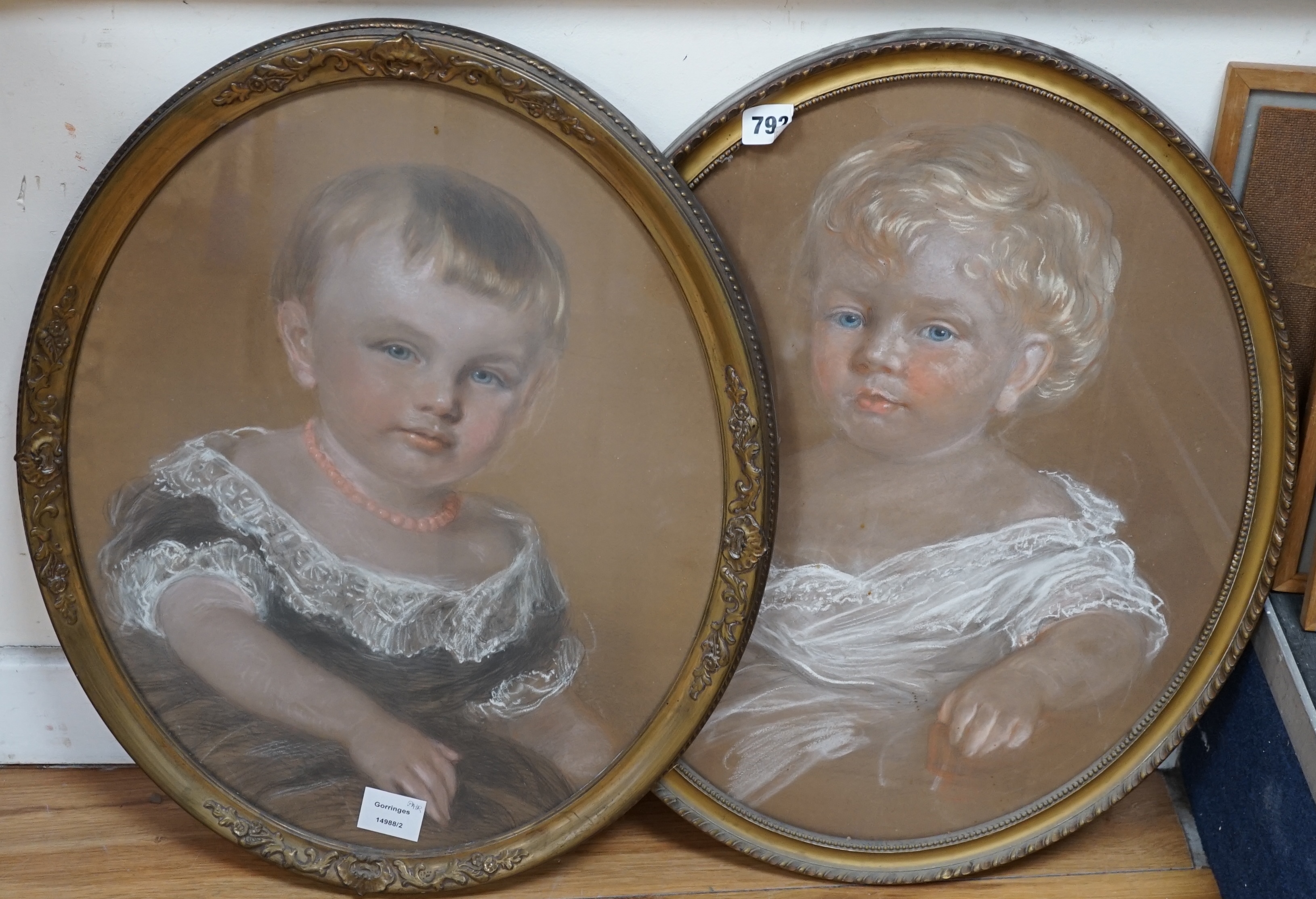 19th century English School, pair of oval heightened pastels, Portraits of infants, one indistinctly signed in pencil, 50 x 40cm. Condition - fair